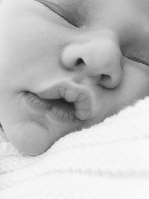 Black and white newborn photo of lips after breastfeeding