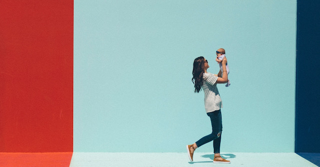 Mom & Baby Walking in front of red, blue, and royal blue wall to promote free webinar for aspiring mamas