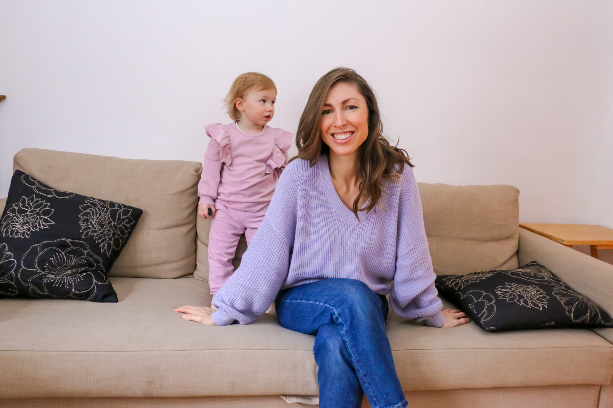 Woman sitting on couch with toddler girl